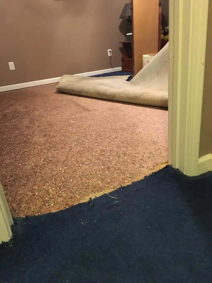 Carpet pad removal revealing water damage during Water Mitigation Services in Lemoore Station